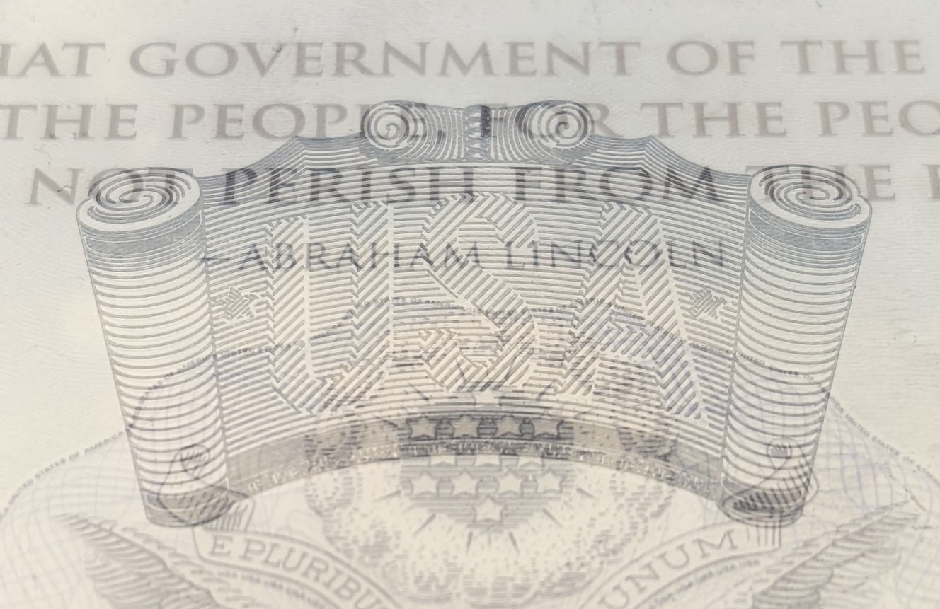 'An engraved image of a scroll reading 'USA.'